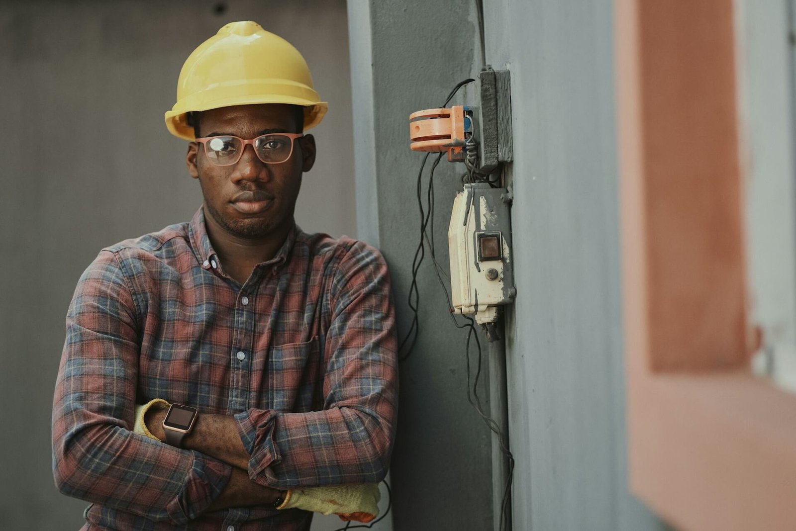 about-emmanuel-ikwuegbu Picture of a measuring tape and yellow hard hat.